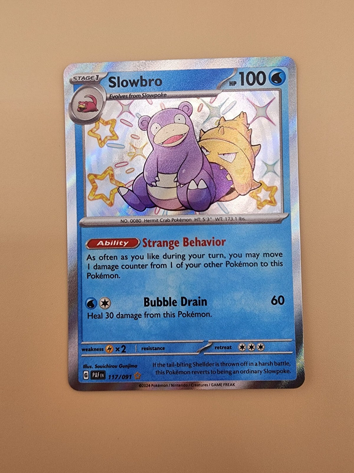 Slowbro 117/091 Paldean Fates Holo Near Mint (NM)