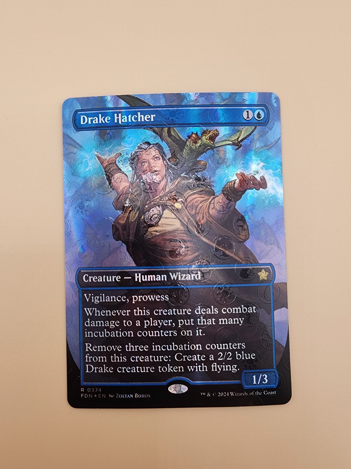 Drake Hatcher (Borderless) (Mana Foil) Foundations Foil NM